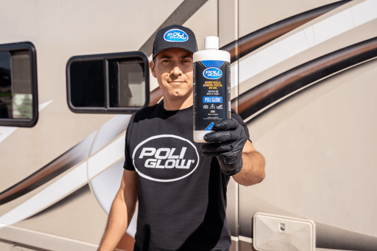 A man wearing a Poli Glow hat and Poli Glow shirt holding a bottle of Poli Glow in front of an RV
