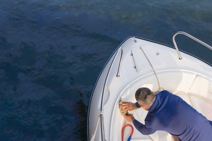 A man detailing the interior of his boat