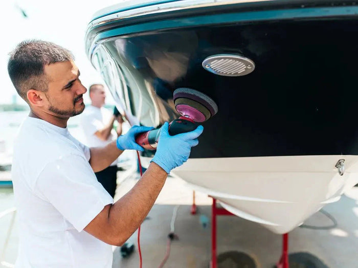 a man buffing the hull of a boat