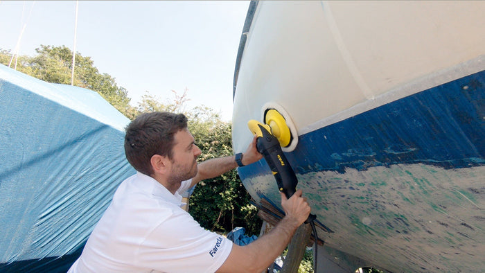 Male buffing a boat working on a gleaming finish for step -by-step guide on boat waxing